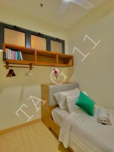 a bedroom with a bed and a book shelf at TA-G-11 @timurbay in Kuantan