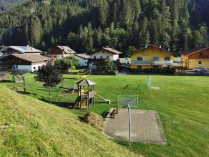 a park with a playground in a field at Appartement Neumayer in Viehhofen