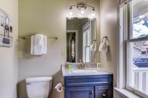 a bathroom with a sink and a mirror and a toilet at Upcountry Inn in Helen