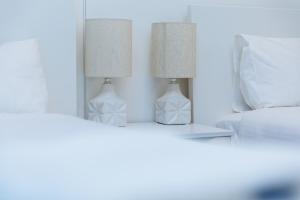 two lamps on a table next to a bed at AirTrip Apartments at Woolloongabba in Brisbane