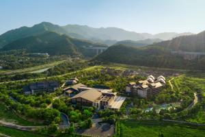 an aerial view of a resort with mountains in the background at New World Qingyuan Hotel -formerly KHOS QINGYUAN in Qingyuan