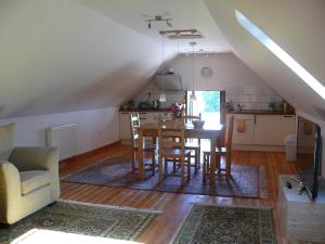 a kitchen and dining room with a table and chairs at The Motor House in Ledbury