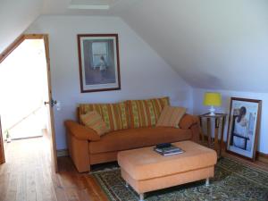 a living room with a couch and a table at The Motor House in Ledbury