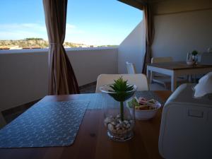 a table with a vase on top of a table at B&B Vivere San Vito Lo Capo in San Vito lo Capo