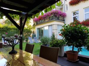 a patio with a table and chairs and flowers at Business Home Vienna in Vienna