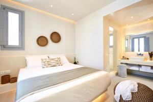 a hotel room with a large bed and a large window at Nova Luxury Suites in Pyrgos