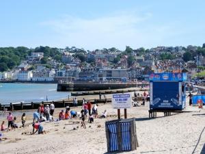 a group of people on a beach near a pier at Amberlea Guest House in Swanage