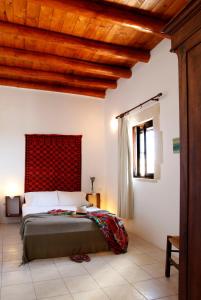 1 dormitorio con 1 cama con cabecero rojo en 1891 Home, en Epáno Kefalás