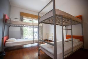 two bunk beds in a room with a window at HI Porto - Pousada de Juventude in Porto