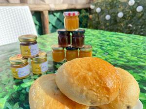 a table with bread and jars of honey on it at The Dream in Massa Lubrense