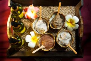 a tray with four bowls of food and some flowers at B Hotel in Khon Kaen