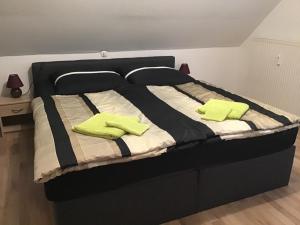 ein schwarzes Bett mit zwei hellgrünen Kissen darauf in der Unterkunft Sonja & Andi in Stockach