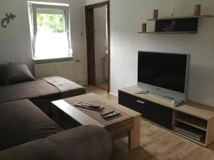 a living room with a couch and a flat screen tv at Beim Andi in Stockach