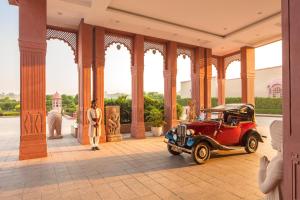an old red car parked inside of a building at Orchha Palace and Convention Centre in Orchha