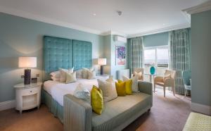 a bedroom with a large bed and a couch at Roslin Beach Hotel in Southend-on-Sea
