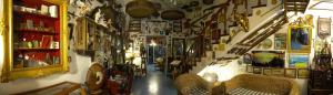 a room with a hallway with chairs and a wall filled with pictures at Hotel Oriente in Lipari