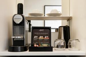 a kitchen shelf with a coffee maker and a counter top at Boutique Hotel Notting Hill in Amsterdam