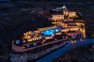 an aerial view of a mansion at night at Petani Bay Hotel - Adults Only in Vóvikes