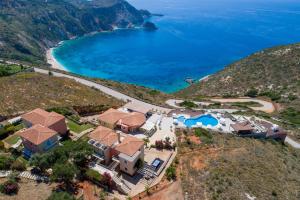 an aerial view of a house on a hill with a beach at Petani Bay Hotel - Adults Only in Vóvikes