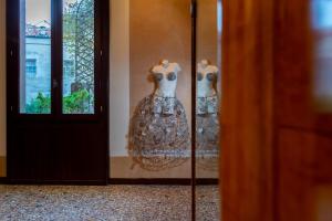 a display case with two dresses in a window at Ca' Pisani Hotel in Venice