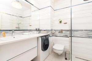 y baño blanco con lavadora. en Apartamenty blisko Starego Miasta - Angielska Grobla by Noclegi Renters, en Gdansk