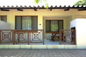 a front porch of a house with two chairs at St Lucia Palms in St Lucia