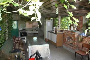 a kitchen and a living room with a table at Robinson Crusoe in Lagodekhi