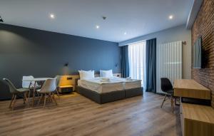 a bedroom with a bed and a table and chairs at Gudauri, Atrium Suites in Gudauri +30 photos