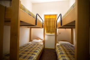 a room with two bunk beds and a window at HI Aveiro – Pousada de Juventude in Aveiro