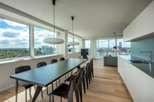 a dining room with a table and chairs and windows at STAY Bryggen in Copenhagen