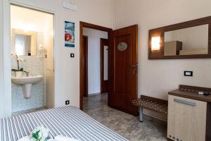 a bedroom with a bed and a sink and a mirror at Locanda dell'Adriatica in San Vito Chietino