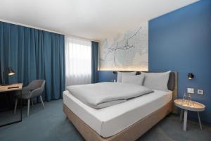 Postel nebo postele na pokoji v ubytování H4 Hotel Leipzig + 37 fotografií