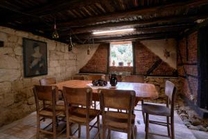 a dining room with a wooden table and chairs at Boutique guest house "SamiKan" in Elena