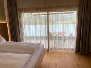 a bedroom with two beds and a balcony with a table at Buchberg38 in Buchberg bei Herberstein