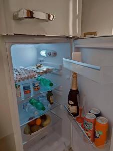 an open refrigerator filled with food and drinks at B&B Duca Orsini in Gravina in Puglia