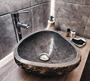 a sink in a bathroom with a stone sink at B&B Duca Orsini in Gravina in Puglia