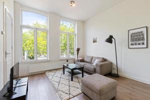 a living room with a couch and a chair at Canal view apartment in the center of Amsterdam - Apt 1 in Amsterdam