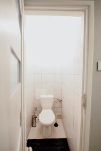 a bathroom with a toilet in a small room at High Standard-University District free parking in Łódź