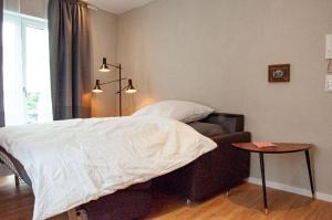 a bedroom with a bed and a chair and a table at Ferienwohnung Marianne in Oberwesel
