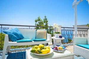 a table with a bowl of fruit on a patio at Villa Azzurra in Conca dei Marini