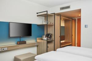 TV a/nebo společenská místnost v ubytování H4 Hotel Leipzig