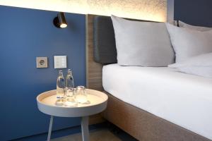 Postel nebo postele na pokoji v ubytování H4 Hotel Leipzig