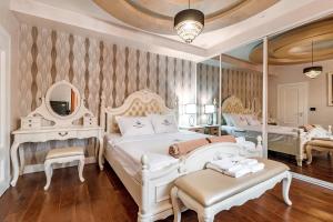 a bedroom with two beds and a mirror at Roof Top Villa Budva in Budva +42 photos