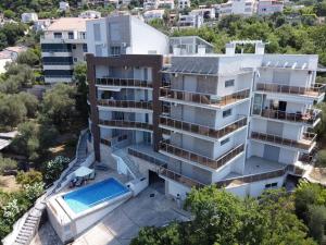 an aerial view of a building with a swimming pool at Sea view Apartments Panorama Przno in Sveti Stefan