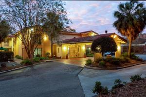 a large house with a driveway in front of it at La Quinta Inn by Wyndham Tallahassee North in Tallahassee