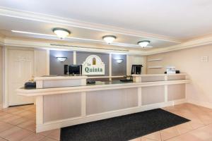 a lobby of a hotel with aania sign on the wall at La Quinta Inn by Wyndham Tallahassee North in Tallahassee