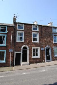 a brick building on the side of a street at Church Cottage in Maryport