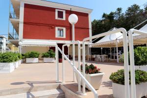 a red building with white stairs in front of a building at b&b Da Morena in Termoli
