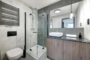 a bathroom with a shower and a toilet and a sink at Old Town Apartments - Św. Barbary street by Renters in Gdańsk