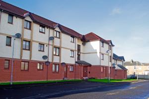 a row of brick buildings on a street at Superb 2 Bedroom Flat in Inverness